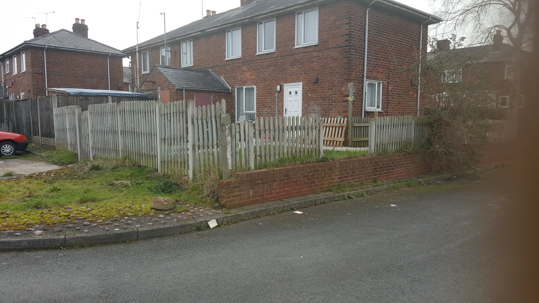 Tired picket fence around a corner garden
