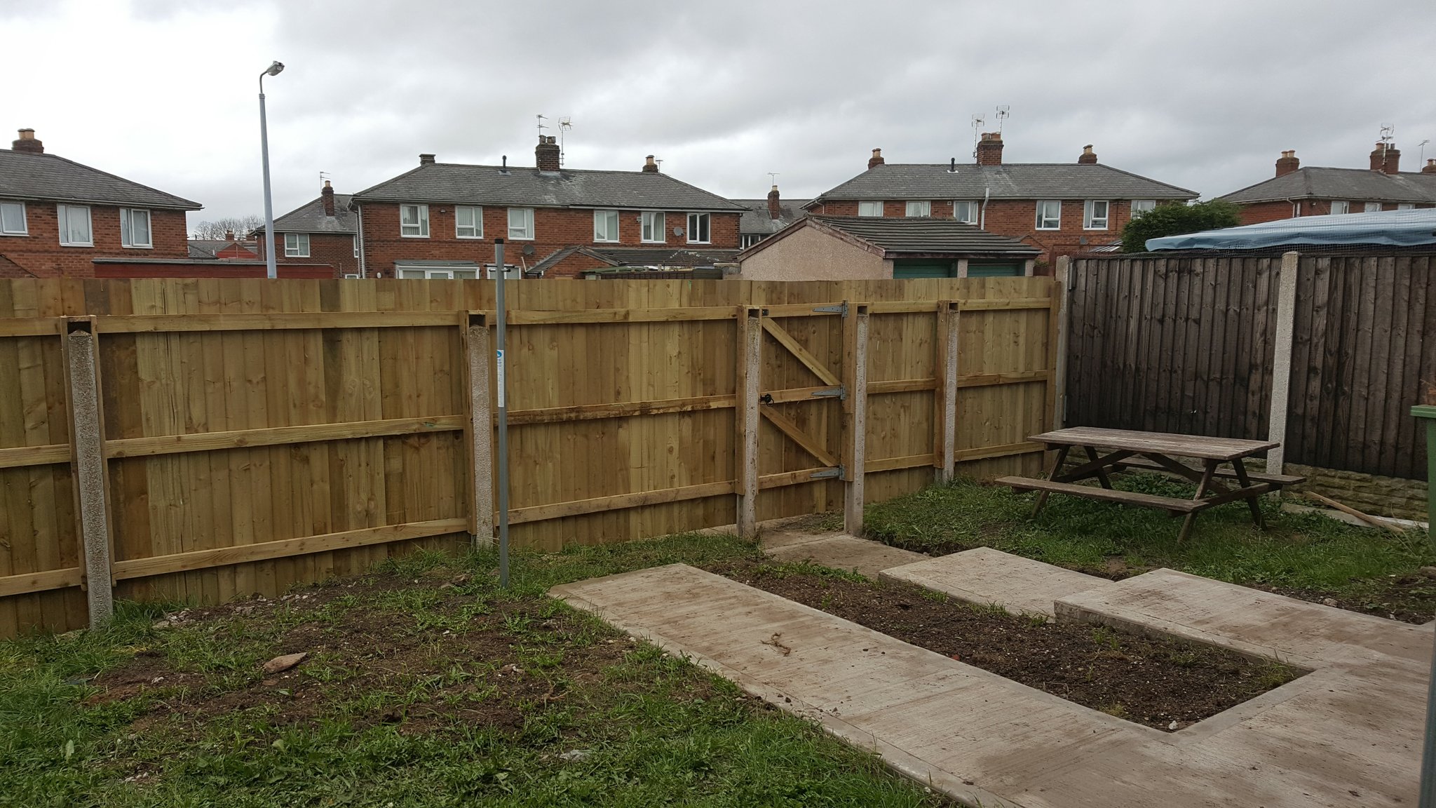 New close-board fence and gate inside a garden