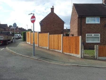 New panel fence along a street corner