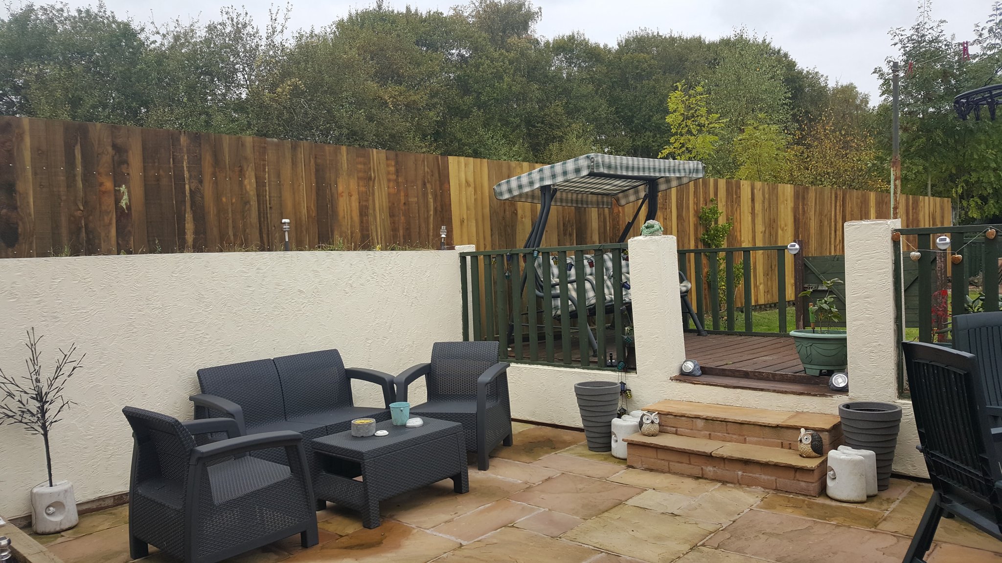 Raised deck with railings and garden seating